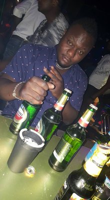 Photo from community reports said to show the operator at a lounge venue in Douala, Cameroon — reportedly used as a legitimate-looking cash-flow front and a meeting point for associated operators.